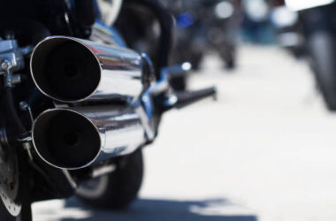 rear view of classical motorcycle pair of exhaust chrome pipes selective focus