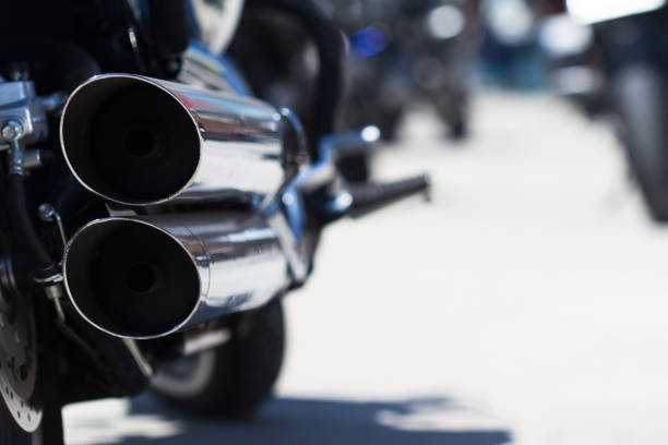 rear view of classical motorcycle pair of exhaust chrome pipes selective focus